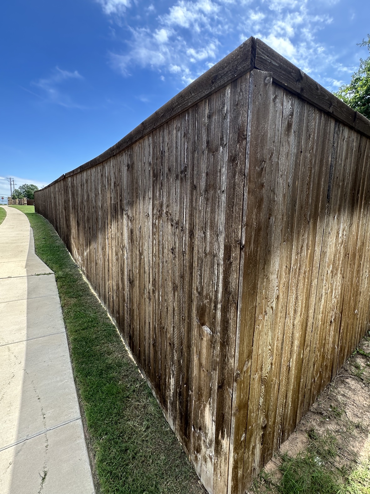 Modern horizontal slat wood fence stained dark in Dallas Fort Worth