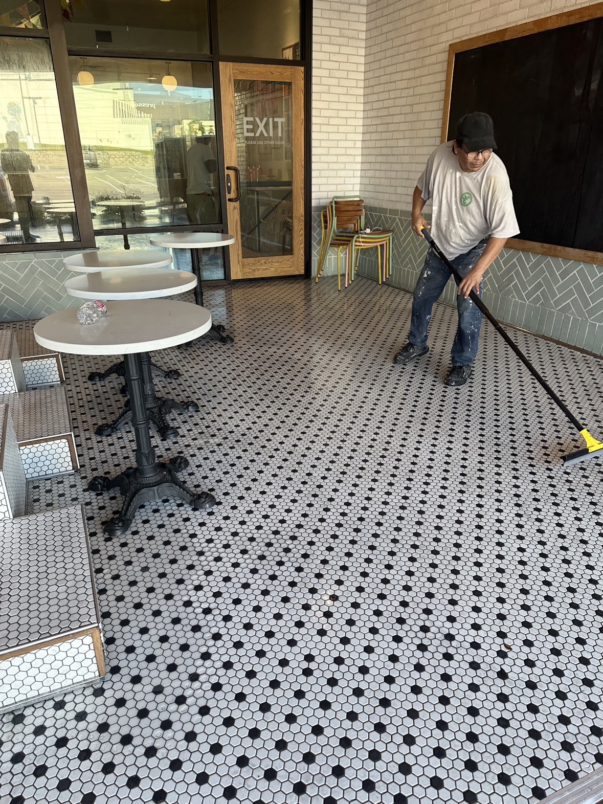Squeegeeing freshly pressure washed tile, professional exterior cleaning Dallas