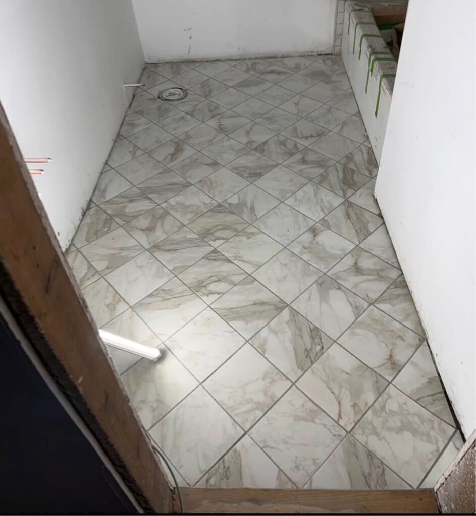 Marble-look diamond pattern tile floor installation by a flooring contractor in Dallas TX