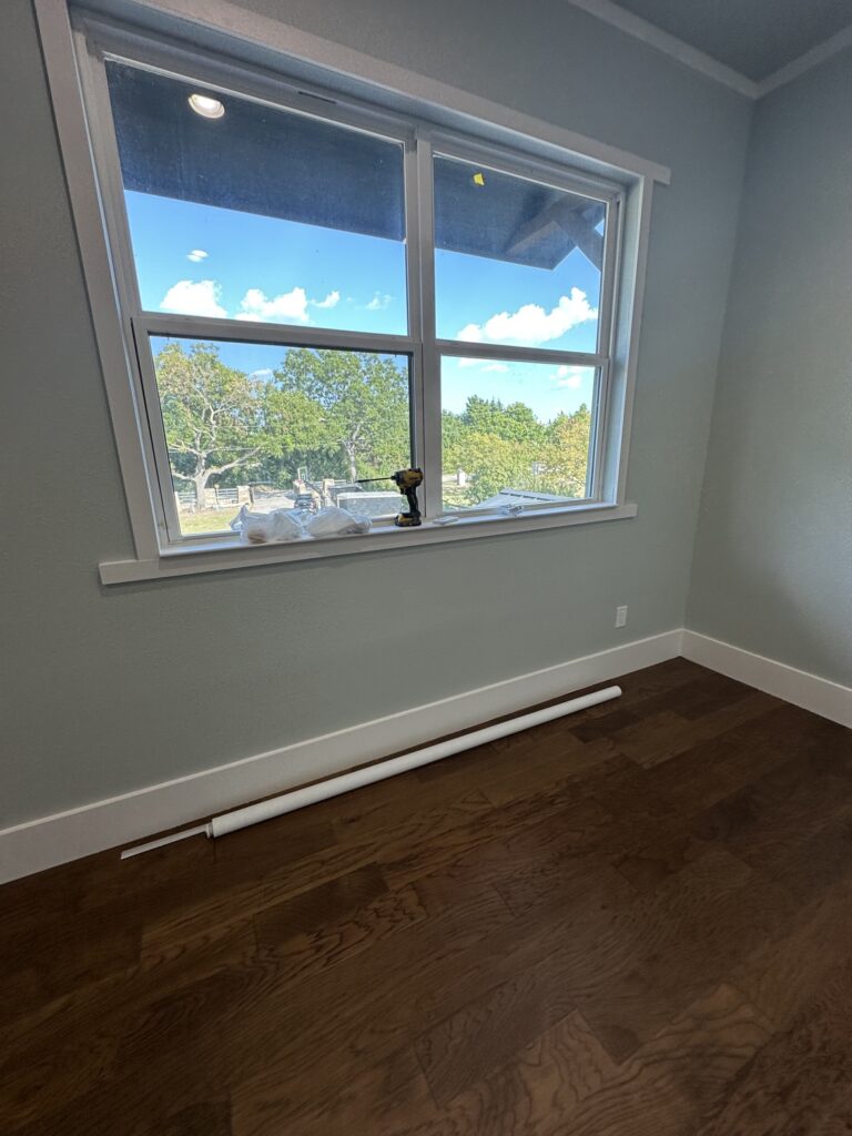 New wood flooring in a freshly painted bedroom, flooring installation in Fort Worth TX