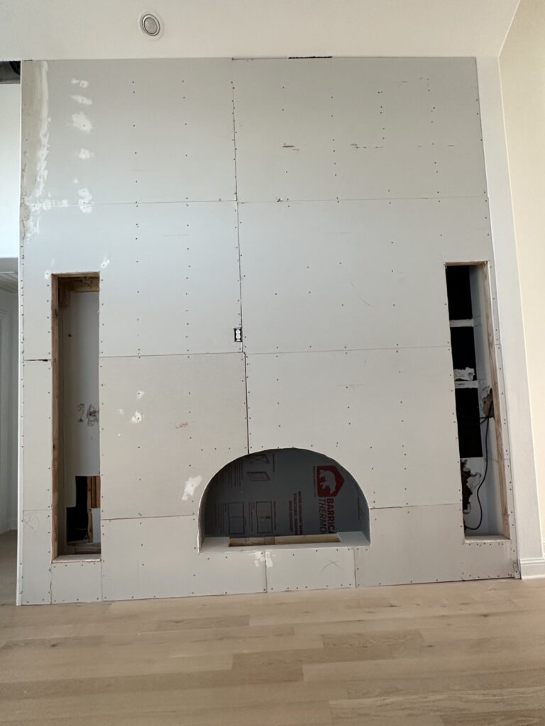 Drywall installed on a floor-to-ceiling fireplace feature wall, drywall company in Dallas Fort Worth TX