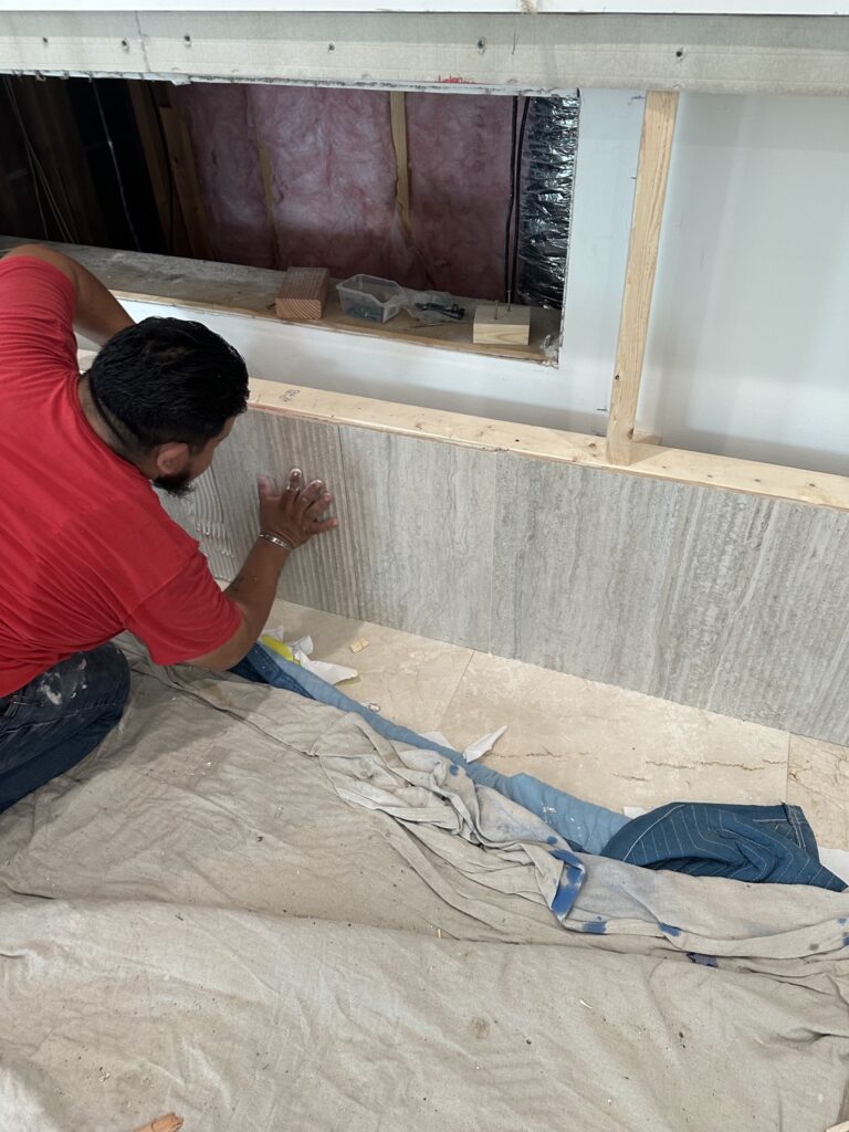 Large format tile wall installation in progress by Terra Renovations, Dallas-Fort Worth tile contractor